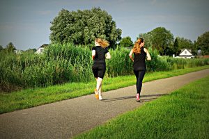 deux femmes en train de courir jogging dans un parc